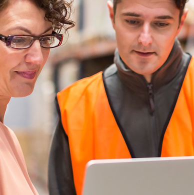 viewing laptop in a high vis jacket